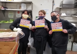 three workers holding UFCW placards