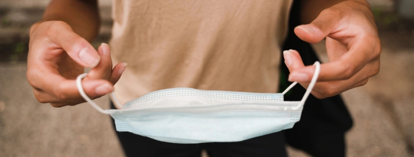 a man holding a facemask
