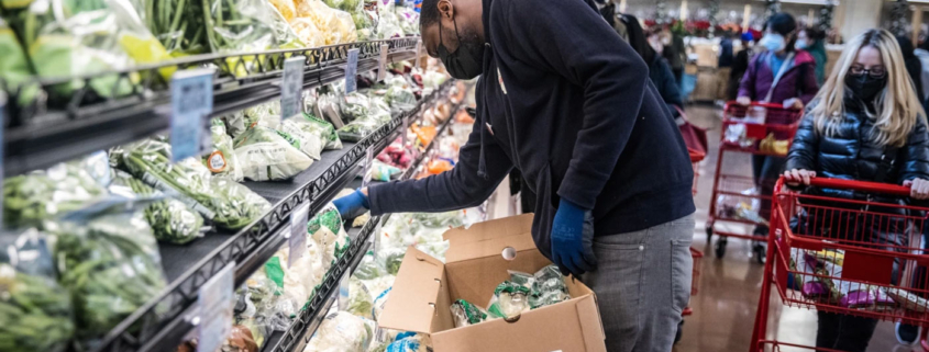 a grocery staff arranging items