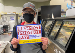 a cake shop staff holding a UFCW placard