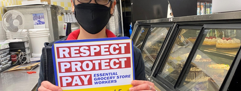 a cake shop staff holding a UFCW placard